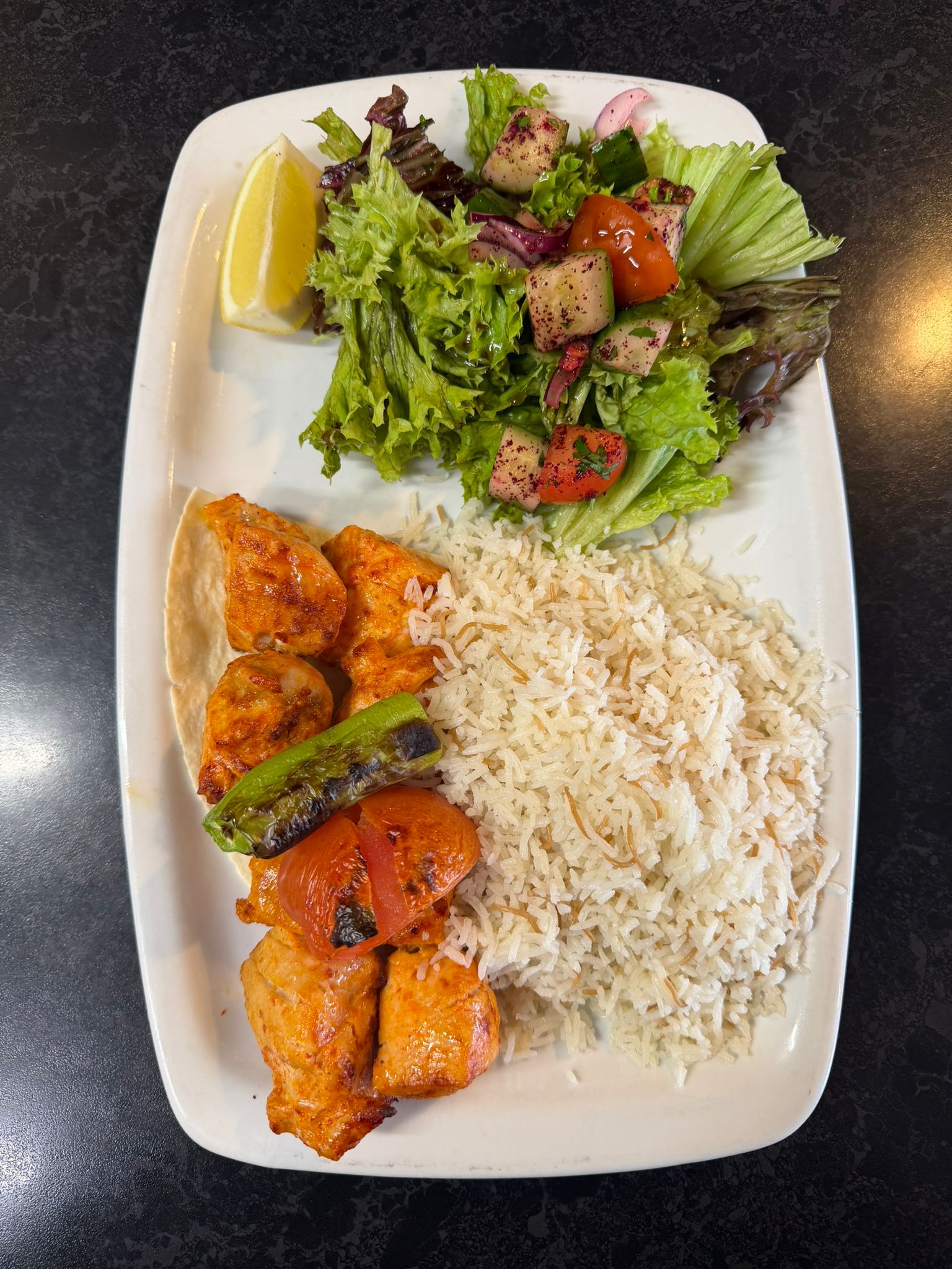 Chicken shish kebab with fluffy rice and fresh mixed salad
